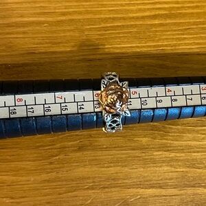 Peach colored rose ring with fancy silver tone around ring size 5 1/2